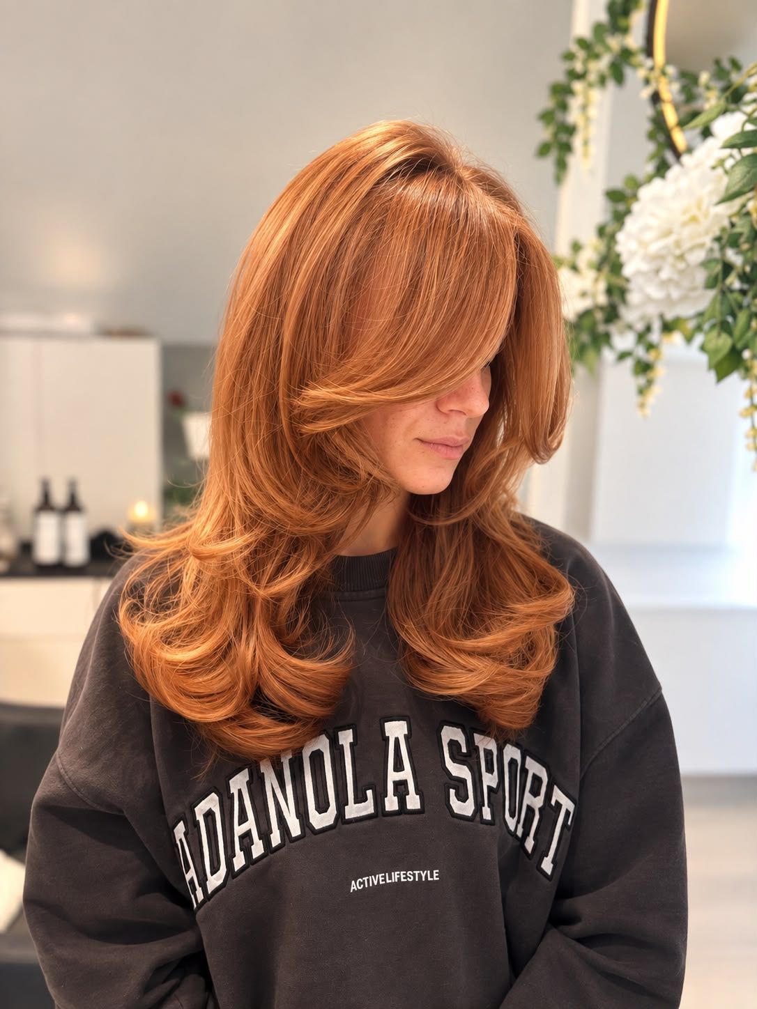 Layered copper ginger hair with a curtain fringe and bouncy blow-dried ends